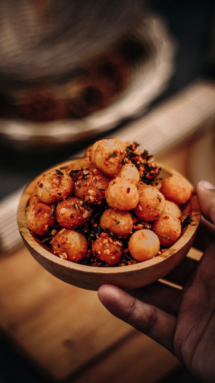 why-choose-us Delicious Indonesian spiced potato balls served in a rustic wooden bowl, perfect for food enthusiasts.