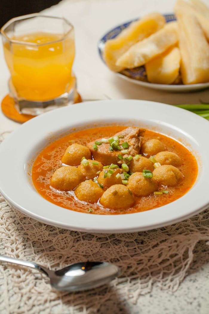 about-01 Homemade Paraguayan soup with cassava and a glass of juice on the side.