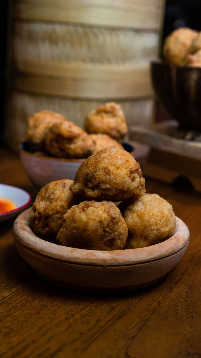 services-02 Delicious homemade Indonesian fried meatballs served in rustic bowls, perfect for a cozy meal.