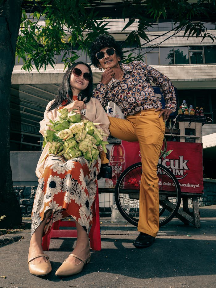 Two street vendors in Jakarta showcase their products with style and smiles.